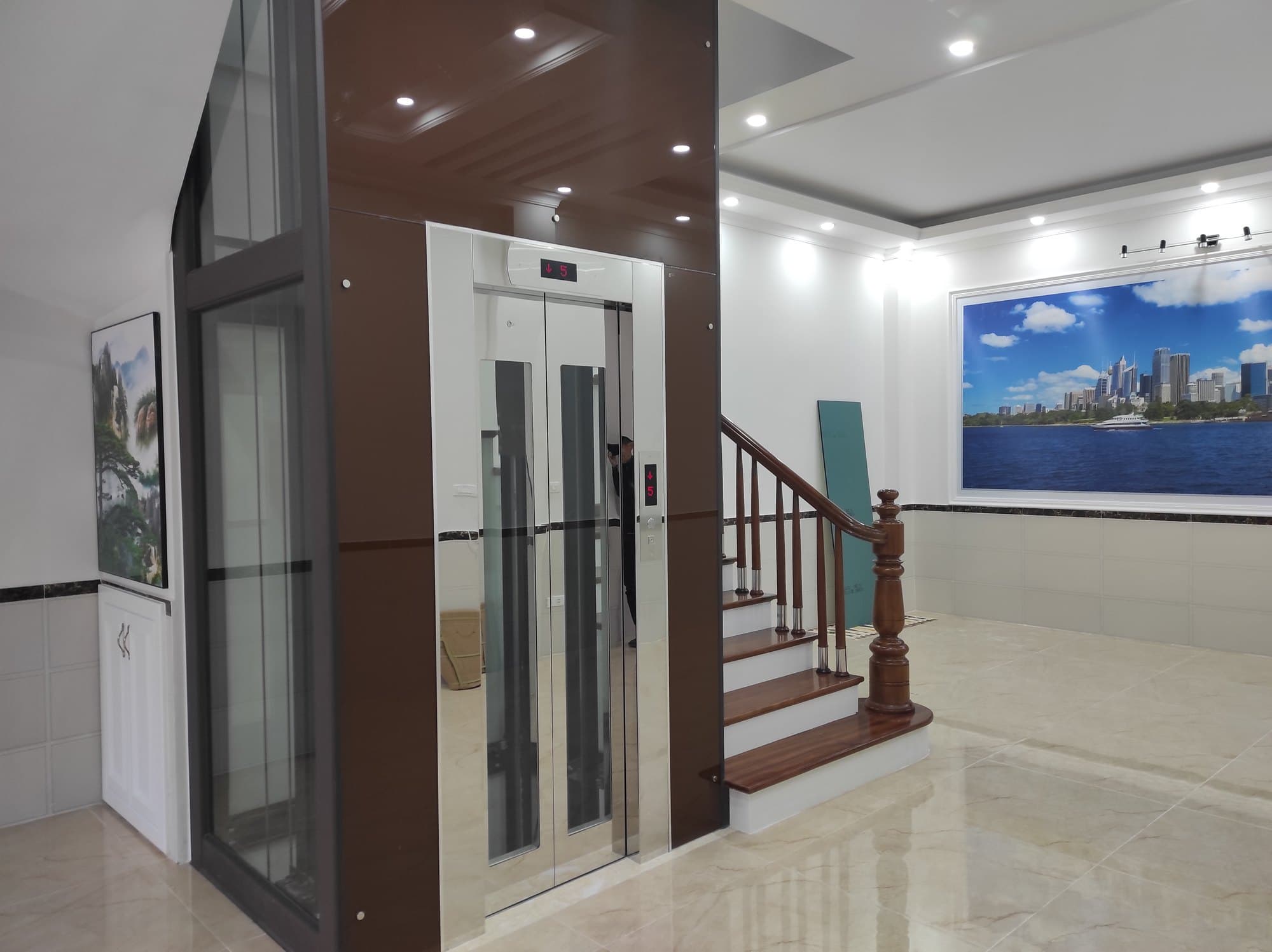 Thang máy FUJI lắp trong nhà phố, hố thang khung thép kính dựng cạnh cầu thang